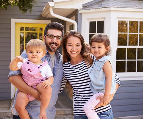 family standing outside of a home