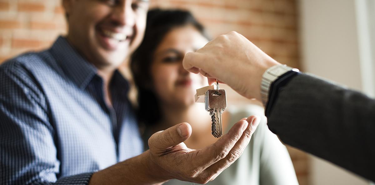 Couple receiving keys to their new home 